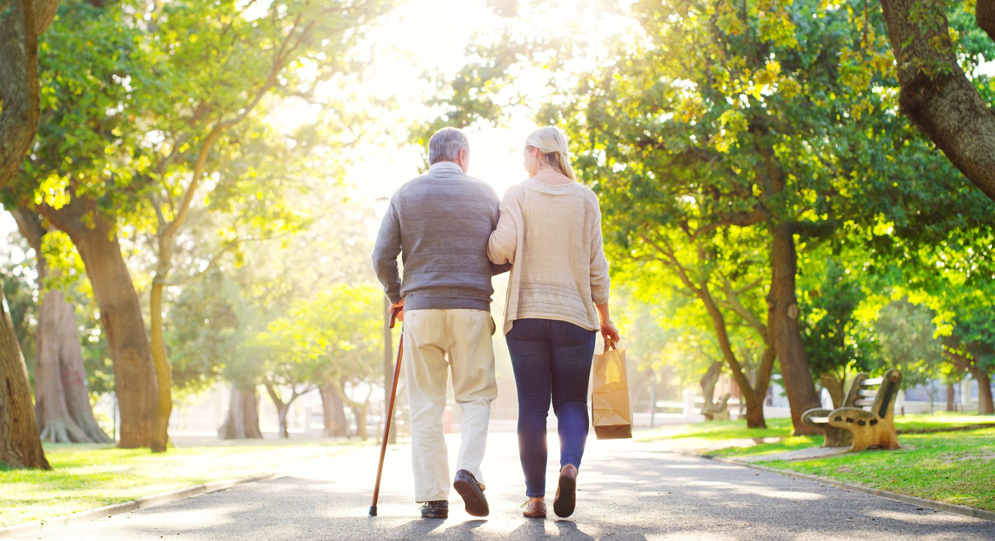 Carent and their elderly parent on a walk Carent and their elderly parent on a walk